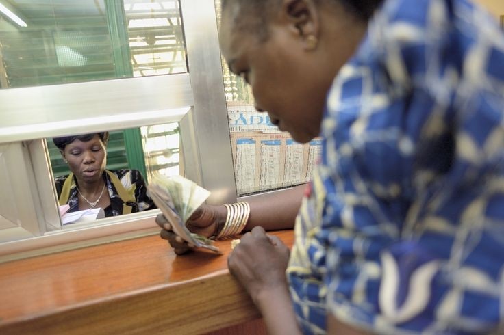 Nigerian community members participating in small-scale savings and community finance through means