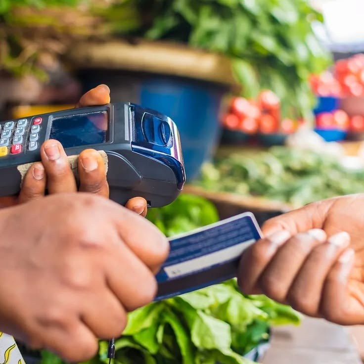 Nigerian using a digital wallet for a cashless transaction supporting the national cashless policy transition